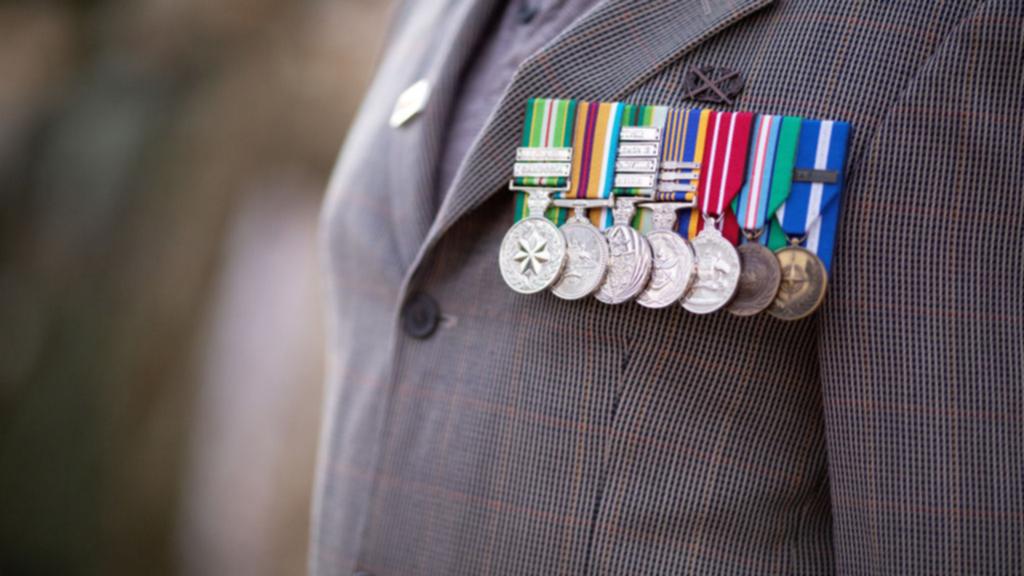 man wearing australian medals with medal ribbon bars